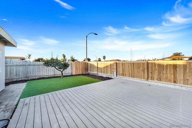 wooden deck featuring a lawn