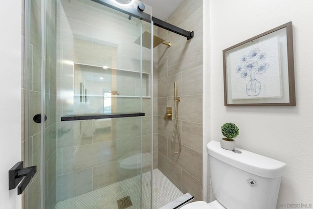 bathroom featuring toilet and an enclosed shower