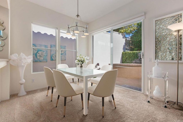 carpeted dining area with an inviting chandelier and plenty of natural light