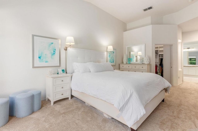 carpeted bedroom featuring lofted ceiling, a walk in closet, and a closet