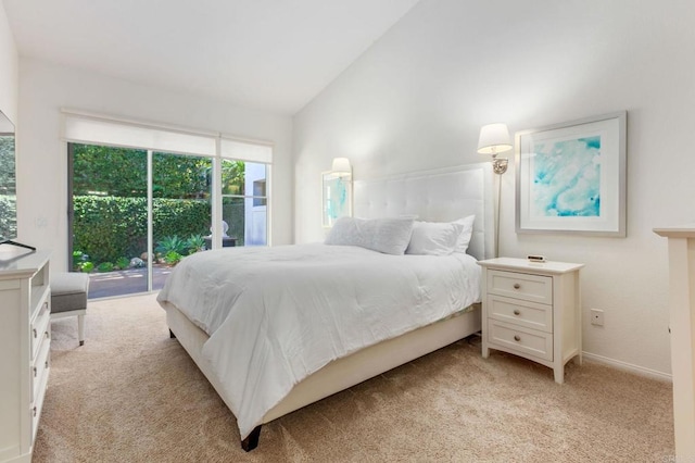 carpeted bedroom with high vaulted ceiling and access to exterior