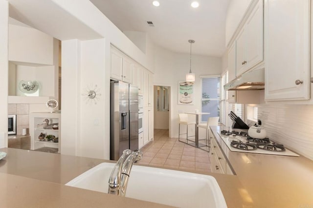 kitchen with sink, decorative light fixtures, white cabinetry, white appliances, and backsplash