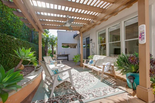 view of patio / terrace with ceiling fan and a pergola