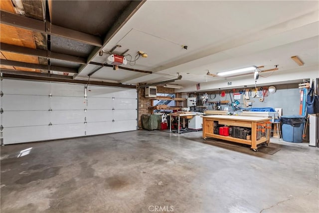 garage with a garage door opener and a workshop area