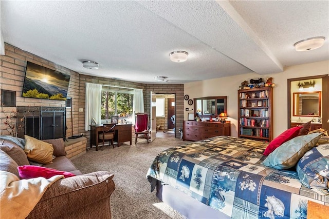 carpeted bedroom featuring a textured ceiling and a fireplace