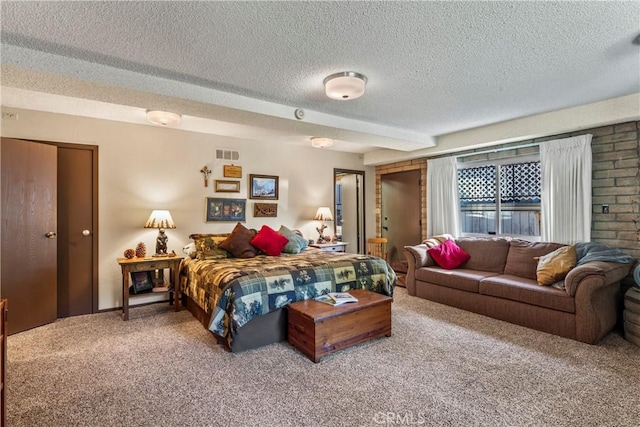 bedroom with a textured ceiling and carpet