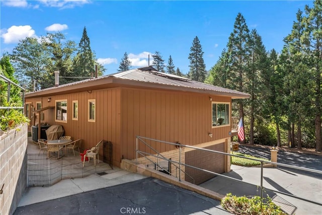 view of side of home featuring a patio area