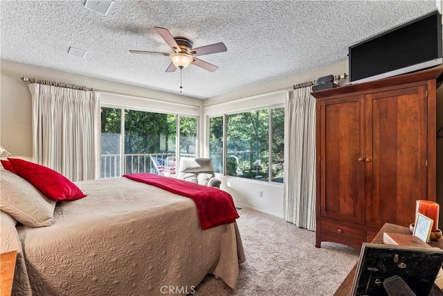 carpeted bedroom with a textured ceiling and ceiling fan