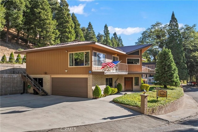 view of front facade featuring a garage and a balcony