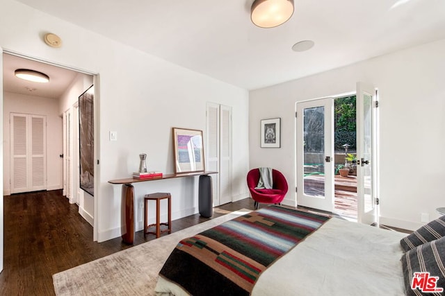 bedroom featuring a closet, french doors, access to exterior, and dark wood-type flooring