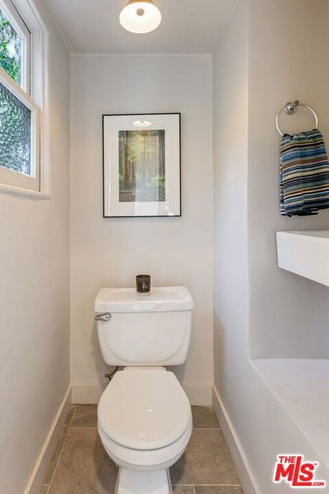 bathroom featuring tile patterned flooring and toilet