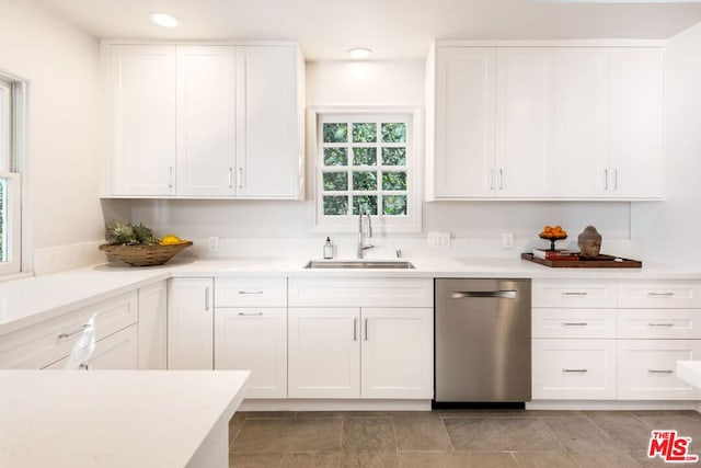 kitchen with white cabinets, dishwasher, and sink