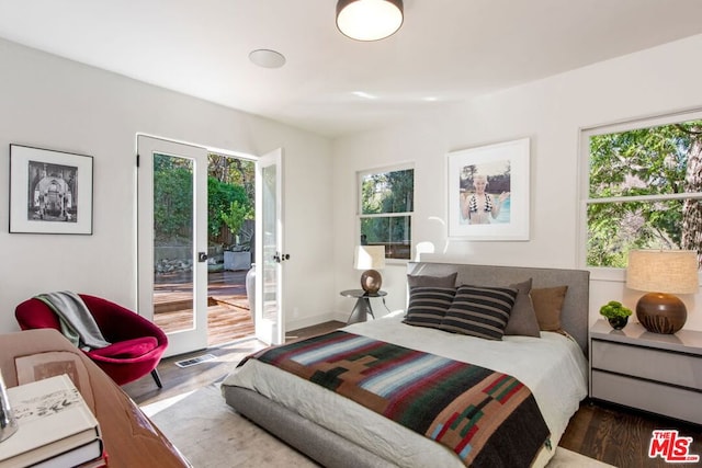 bedroom with french doors, access to outside, and dark wood-type flooring