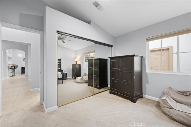 interior space featuring ceiling fan, a closet, and vaulted ceiling