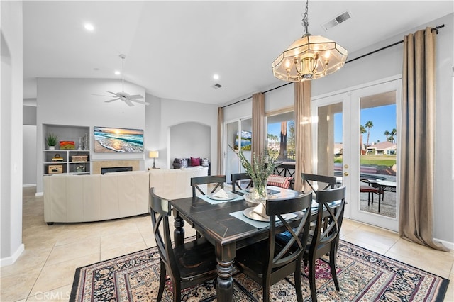 dining space with lofted ceiling, built in shelves, light tile patterned flooring, and french doors