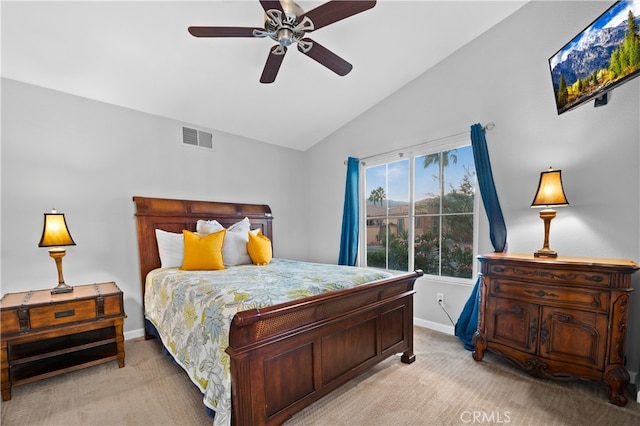 carpeted bedroom with ceiling fan and vaulted ceiling