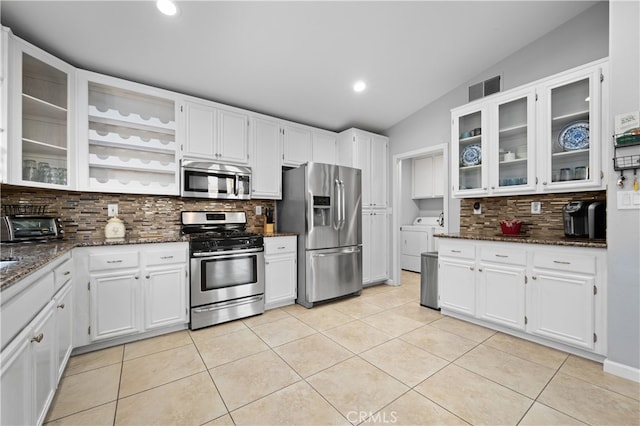 kitchen with white cabinets, dark stone counters, and appliances with stainless steel finishes