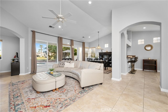 living room featuring ceiling fan, high vaulted ceiling, and light tile patterned floors