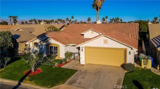 mediterranean / spanish home with a front lawn and a garage