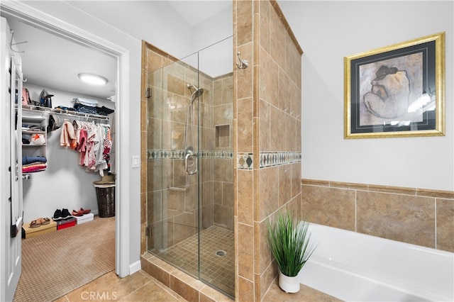 bathroom featuring shower with separate bathtub and tile patterned floors