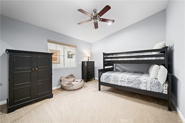 bedroom with lofted ceiling, light colored carpet, and ceiling fan