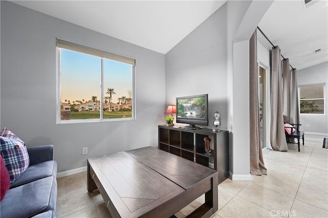 living room featuring light tile patterned flooring and lofted ceiling