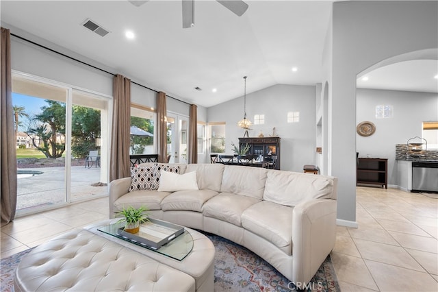 tiled living room featuring ceiling fan and lofted ceiling