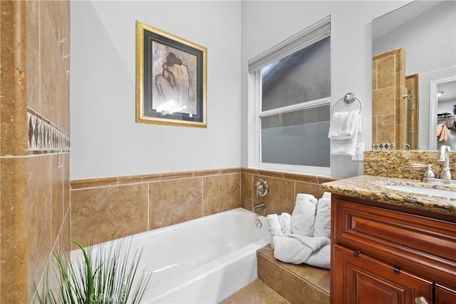 bathroom featuring a tub to relax in and vanity