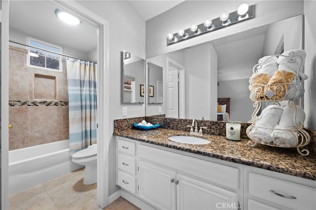 full bathroom with shower / tub combo, tile patterned floors, vanity, and toilet