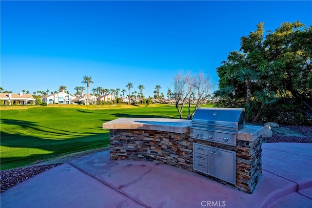 view of patio / terrace with exterior kitchen and a grill