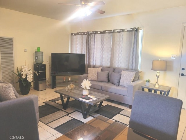 tiled living room with ceiling fan