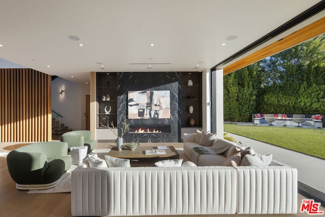 interior space with a premium fireplace and wood-type flooring