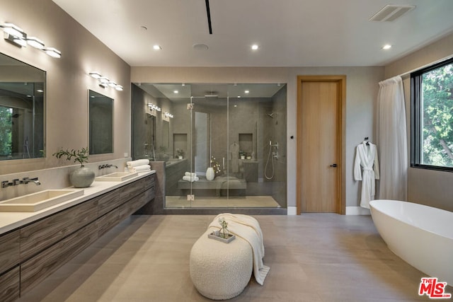 bathroom featuring independent shower and bath and vanity