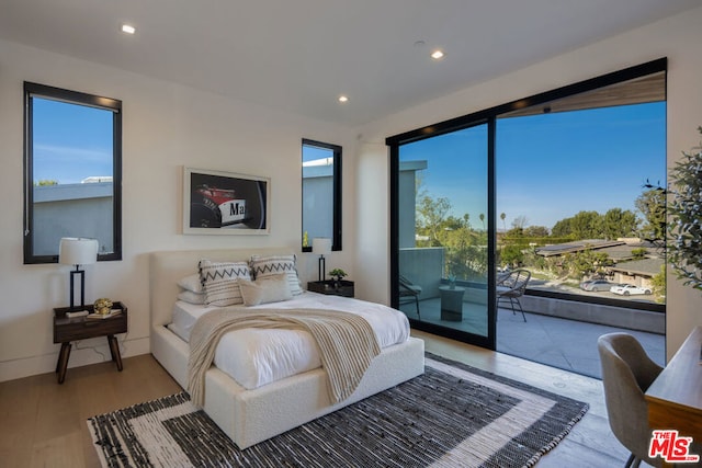 bedroom featuring access to outside and light wood-type flooring