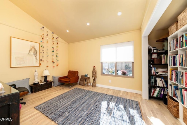 living area featuring recessed lighting, ornamental molding, vaulted ceiling, wood finished floors, and baseboards