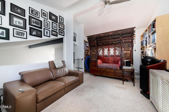 carpeted living area featuring a ceiling fan