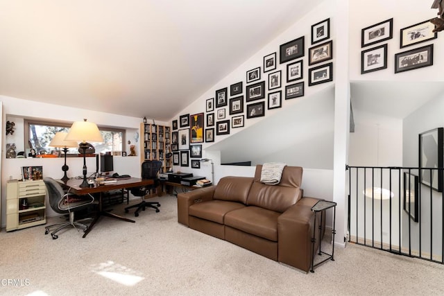 carpeted home office featuring lofted ceiling