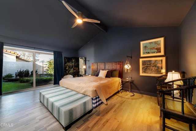 bedroom featuring lofted ceiling with beams, baseboards, wood finished floors, and access to exterior