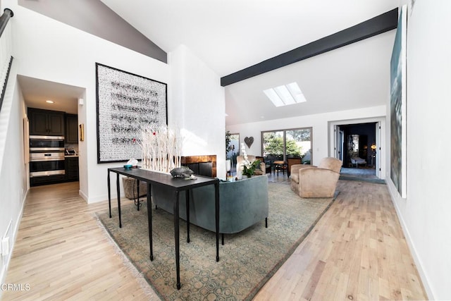 living area featuring high vaulted ceiling, light wood finished floors, beamed ceiling, and baseboards