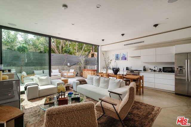 living room with sink and floor to ceiling windows