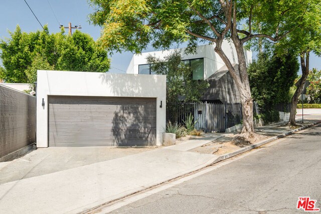 view of front of property featuring a garage and an outbuilding