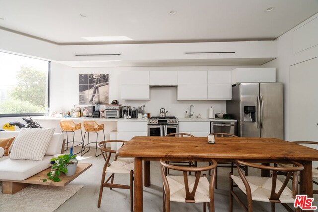 kitchen featuring appliances with stainless steel finishes and white cabinetry