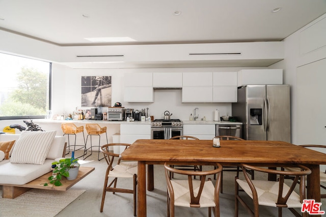 kitchen with white cabinetry and stainless steel appliances