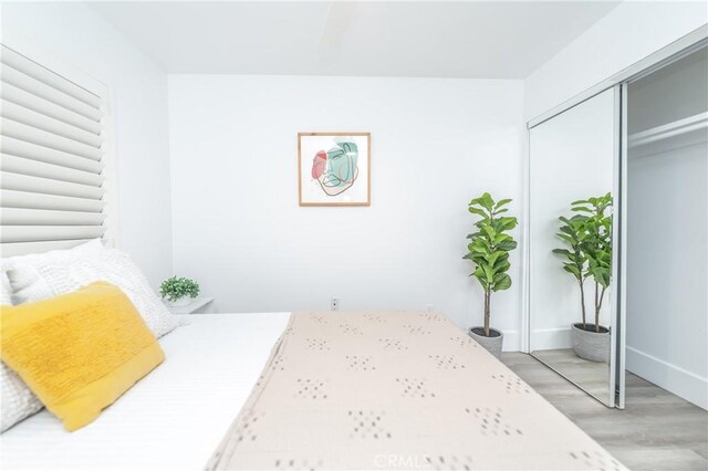 bedroom with a closet and light hardwood / wood-style flooring