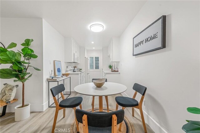 dining area with light hardwood / wood-style floors