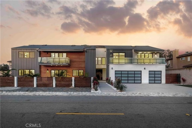 contemporary house featuring a balcony and a garage