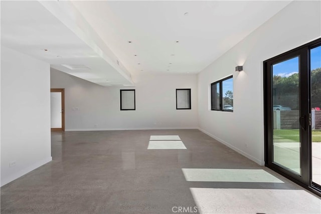 unfurnished room with concrete flooring