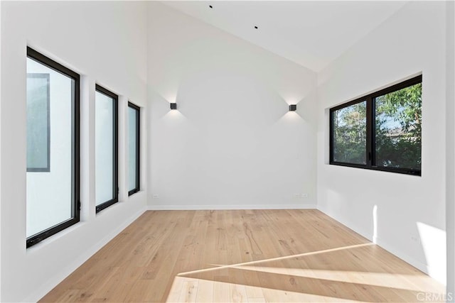 empty room featuring hardwood / wood-style floors and vaulted ceiling