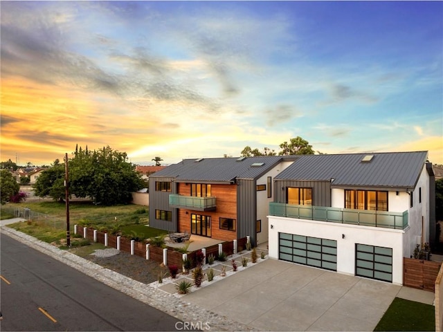 view of front facade featuring a balcony and a garage