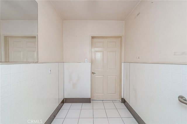 interior space featuring tile walls and light tile patterned flooring